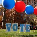 Students on the campus of the University of Pittsburgh walk past a ‘vote’ sign on Election Day, Nov. 5., 2024.