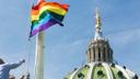 The Pride Flag is raised on a flagpole at the state Capitol building in Harrisburg.