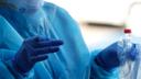 A nurse holds a nasopharyngeal swab and the sample tube during a coronavirus test.