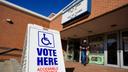 A photo of a sign that shows where to vote.