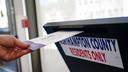 A voter puts a ballot into a drop box on primary Election Day 2024 at Bethlehem City Hall in Northampton County, PA.