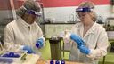 Lab workers at Mid-Atlantic Mothers' Milk Bank fill bottles with donated milk.