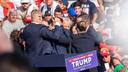 The Secret Service immediately surround former President Donald Trump after he was shot during his campaign stop at the Butler Farm Show grounds.