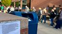 People wait in line outside the Bucks County government building to apply for an on-demand mail ballot on the last day to request one.