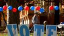 Students on the campus of the University of Pittsburgh walk past a ‘vote’ sign on Election Day, Nov. 5., 2024.