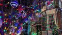 Rowhomes and trees are decked out in holiday lights and ornaments on this stretch of South 13th Street in Philadelphia.