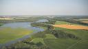 Farmland and marsh are nestled together along Tuckahoe Creek in Maryland. The creek flows into the Choptank River, which in turn enters the Chesapeake Bay.