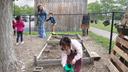 Diana McGuire leads her 4-year-old son Noah by the hand across the playground at St. Mary's Early Childhood Center in Indianapolis, Ind., May 13, 2026.