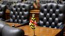 A miniature Maryland flag stands on a desk in the Maryland House of Delegates in Annapolis, Md., Wednesday, Jan. 14, 2015, the first day of the 2015 legislative session.