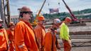 U.S. Steel employees walk to greet company and government officials at the announcement of up to $2.5 billion in investment into upgrades at the Mon Valley Works on Monday, June 8, 2026, at Edgar Thomson Plant in Braddock.