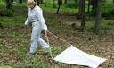 Dr. Danielle Tufts collects ticks for research by dragging a cloth along the ground.