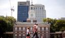 People move past Independence Hall at the Independence National Historical Park in Philadelphia, Aug. 25, 2016.