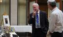 Rabbi Jeffrey Myers of the Tree of Life Congregation, left, reminisces over images presented at his retirement dinner celebration at Rodef Shalom Congregation in Pittsburgh on Friday, July 17, 2026.