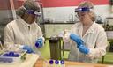 Lab workers at Mid-Atlantic Mothers' Milk Bank fill bottles with donated milk.