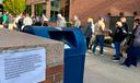 People wait in line outside the Bucks County government building to apply for an on-demand mail ballot on the last day to request one.