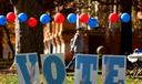 Students on the campus of the University of Pittsburgh walk past a ‘vote’ sign on Election Day, Nov. 5., 2024.