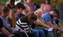 Attendees react during a vigil in Spring Grove, PA, after multiple police officers were shot and killed.