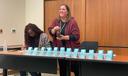 Christa Miller, Lancaster County’s election director, shakes a bottle filled with red, numbered marbles to determine the winner of tied races.