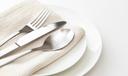 A stock image of a plate, silverware, and napkin.