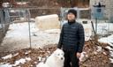 Ge Fangyuan, a farmer in Washington Township, stands with his dog for a portrait at the farm Feb. 20, 2026. Fangyuan's farm was disrupted after a sewer main break dumped about 8,000 gallons of raw sewage in November 2024.