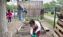 Diana McGuire leads her 4-year-old son Noah by the hand across the playground at St. Mary's Early Childhood Center in Indianapolis, Ind., May 13, 2026.