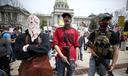 Protesters and militia gathered outside the Capitol in Harrisburg this April for a reopen protest. A recent report by a worldwide nonprofit that tracks militia groups said Pennsylvania is one of five U.S. states at high risk of violence through Nov. 3.