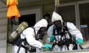 Members of the Pennsylvania State Police Clandestine Lab Response Team remove chemicals from the front porch of a home in Minersville in 2013.