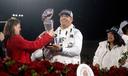 Penn State head football coach James Franklin is presented with the Rose Bowl trophy as President Bendapudi looks on.