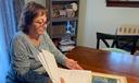Cyndi Compton looks through papers in her Tioga County home.