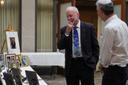 Rabbi Jeffrey Myers of the Tree of Life Congregation, left, reminisces over images presented at his retirement dinner celebration at Rodef Shalom Congregation in Pittsburgh on Friday, July 17, 2026.