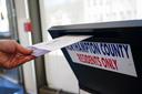 A voter puts a ballot into a drop box on primary Election Day 2024 at Bethlehem City Hall in Northampton County, Pennsylvania.