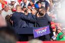 The Secret Service immediately surround former President Trump after he was shot during his campaign stop at the Butler Farm Show grounds on Saturday, July 13, 2024.