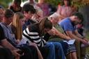 Attendees react during a vigil in Spring Grove, PA, after multiple police officers were shot and killed.