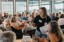 Spotlight PA Rural Affairs Reporter Marley Parish collects quiz sheets at the 2024 Clink and Think Quiz Bash Fundraiser at Axemann Brewery in Bellefonte.