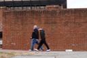 People walk past locations of the now removed explanatory panels that were part of an exhibit on slavery.