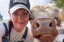April Crossley with pet Highland cow