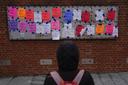 A person views posted signs on the locations of the now removed explanatory panels that were part of an exhibit on slavery at President's House Site in Philadelphia, Jan. 23, 2026.