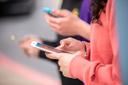 A person holds a cellphone in their hands
