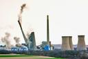 The smokestacks of the former coal-fired Homer City Generating Station crumble in a planned demolition to make way for a new natural gas-fired power plant.