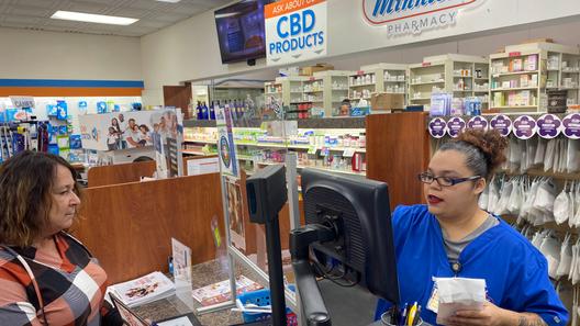 Customer Lisa Durs is helped by pharmacy clerk Kira Tomoney at Minnich's Pharmacy in York County.