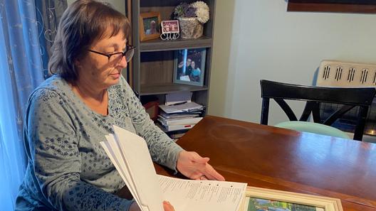 Cyndi Compton looks through papers in her Tioga County home.