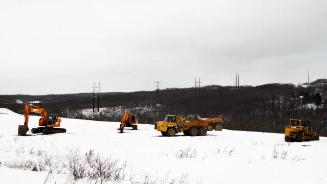 A high-voltage powerline runs behind a construction site in Archbald, PA.