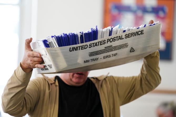 Workers sort mail ballots on Nov. 5, 2024, at Northampton County Courthouse in Easton, Pennsylvania.