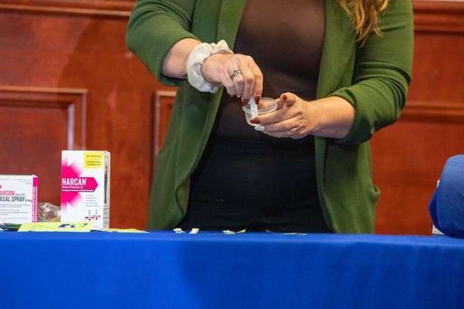A person demonstrates how to use drug test strips.