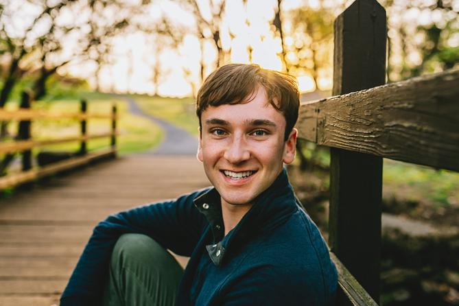 Young man at a bridge near the woods