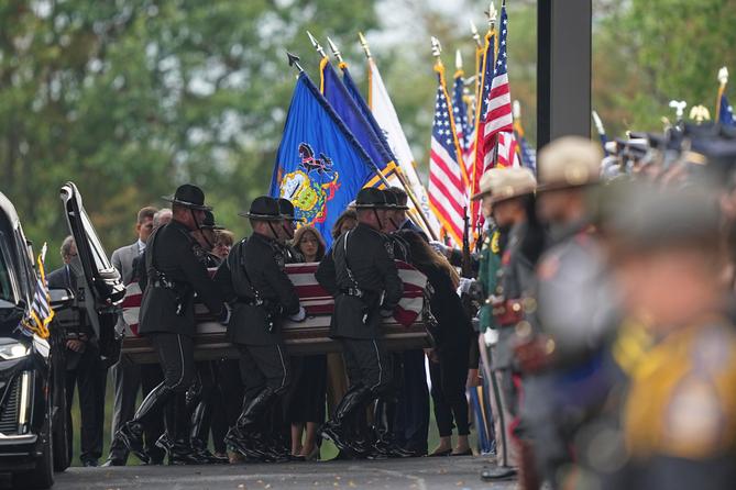 Pallbearers carry the coffin of a slain officer during funeral services for Northern York County Regional Police detectives in Red Lion, PA