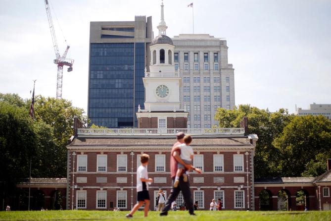 People move past Independence Hall at the Independence National Historical Park in Philadelphia, Aug. 25, 2016.