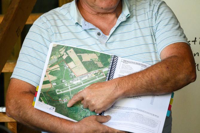 An attendee holds a map at a Benner Township neighborhood meeting about PFAS contamination in June 2022.