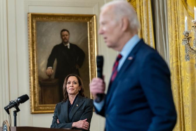 Vice President Kamala Harris looks on as President Joe Biden delivers remarks in the East Room of the White House.