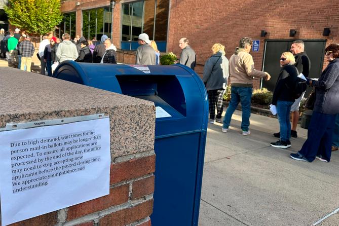 People wait in line outside the Bucks County government building to apply for an on-demand mail ballot on the last day to request one.